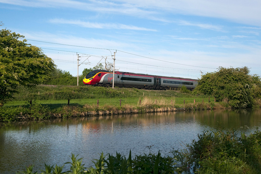 390136, VT 06.10 Manchester Piccadilly-London Euston (1A05, 1E), Bugbrooke SP679564 
 The wind is just beginning to ripple the water on the Grand Union Canal as 390136 'City of Coventry' passes heading south with the 06.10 Manchester to Euston. This bucolic scene was captured near the village of Bugbrooke on the Weedon Loop on the southern WCML. 
 Keywords: 390136 1A05 Bugbrooke SP679564