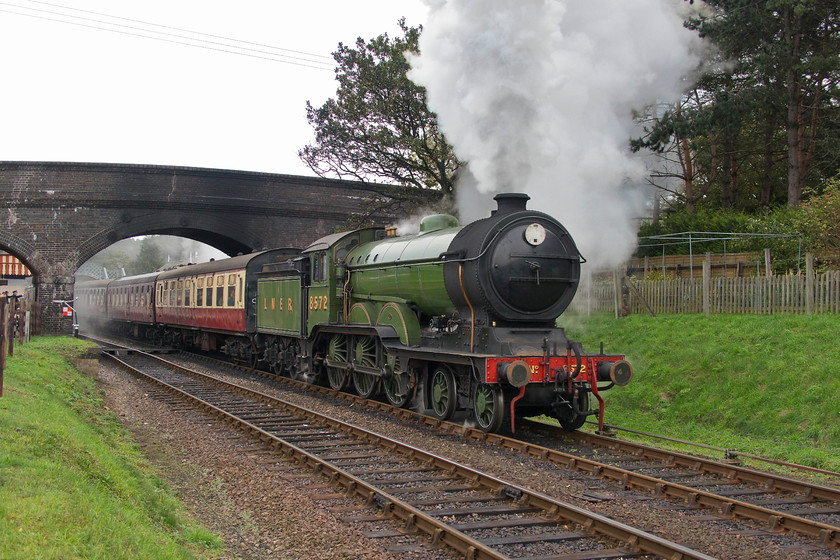 8572, 10.30 Sheringham-Holt, Weybourne station 
 Ex. LNER B12 4-6-0 8572 gets noisily under-way from Weybourne station with the 10.30 Sheringham to Holt working. It was a damp morning and the B12 had one or two slips on the greasy rails, the driver was ready and got it under control as it picked up speed for the assault of Kelling Bank ahead. 
 Keywords: 8572 10.30 Sheringham-Holt Weybourne station