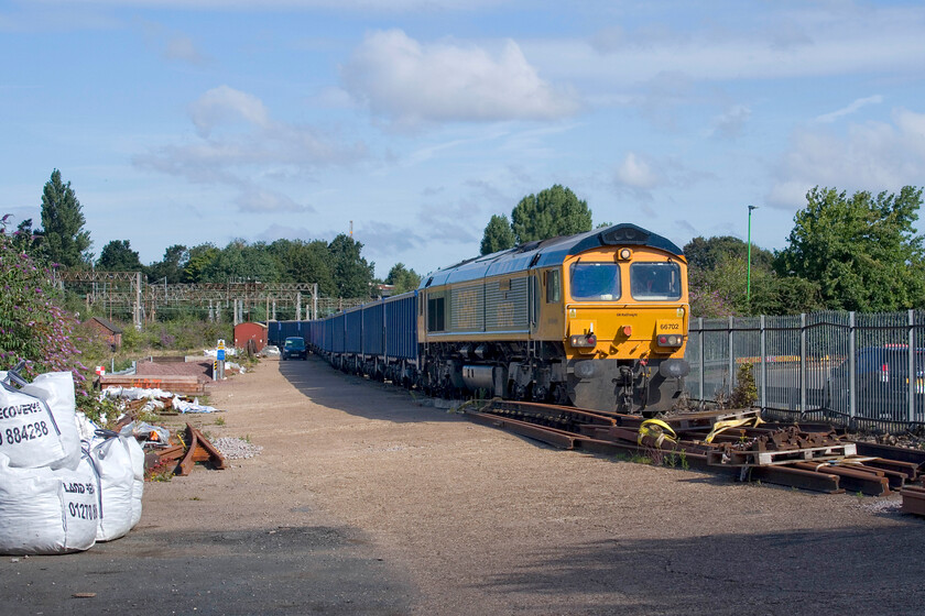 66702, 03.41 Tunstead Sidings-Northampton Castle Yard (6B99, 2L), Northampton Castle Yard 
 As I was popping the car back to a parking spot away from the station the daily 6B99 (or similar) Tunsetad to Northampton Castle yard loaded stone train had just arrived led by 66702 'Blue Lightening'. It was just setting back into a short siding from the headshunt so that the stone could be unloaded by the JCBs. The virtual quarry that has grown over recent years in the castle Yard sees a lot of daily activity with regular lorry movements in and out on the streets of Northampton. The locals also have to put up with a fair amount of dust when it is dry and the wind is blowing from the west. 
 Keywords: 66702 03.41 Tunstead Sidings-Northampton Castle Yard 6B99 Northampton Castle Yard GBRf Blue Lightening