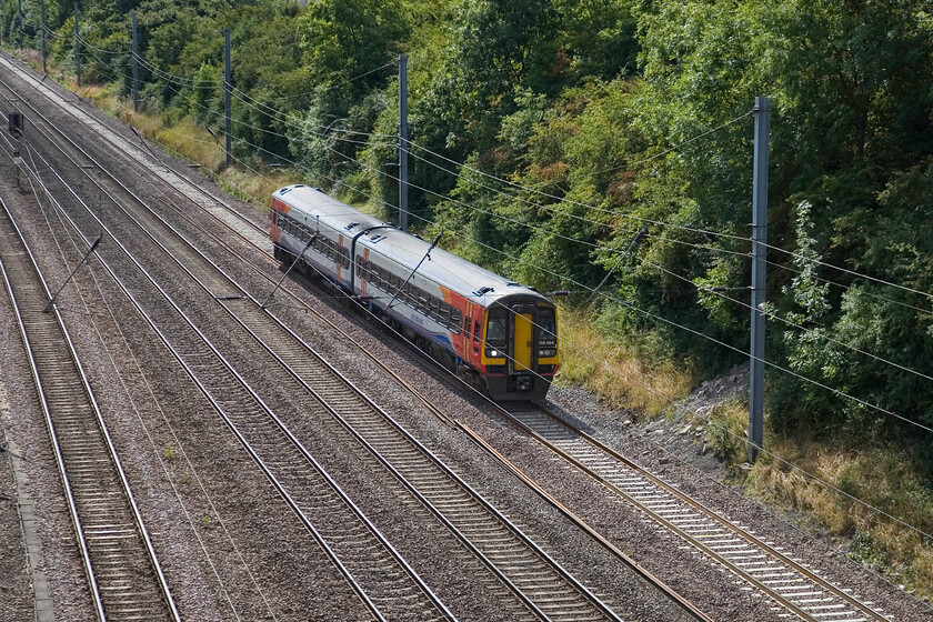 158864, EM 08.57 Norwich-Liverpool Lime Street (1R74), Westby SK96227 
 Sidelined to the down slow line the 1R74 08.57 Norwich to Liverpool East Midlands Trains' service is slowly preparing to pass on to the down fast line a short distance behind where I am standing. However, the passage of a couple of faster services would take priority inducing a delay to the Liverpool train. 158864 is working the service at a very remote spot near the Lincolnshire village of Westby. 
 Keywords: 158864 08.57 Norwich-Liverpool Lime Street 1R74 Westby SK96227 East Midlands Trains