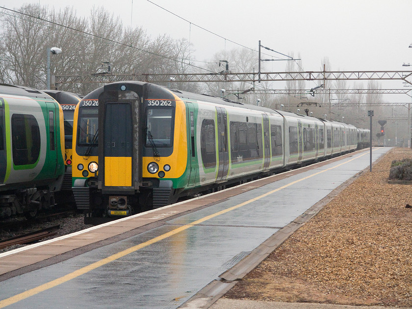 350262, ECS for 10.00 Northampton-Birmingham New Street (2Y97), Northampton station 
 350262 eases slowiny into Nrthampton's number three platform having made the short journey from the Kingsheath EMUD. It is about to join the 08.24 from London Euston that is already waiting with it interconnecting doors open at the platform. The eight-car unit will then leave form Birmingham as the 10.00 off Northampton that my son and I took all the way. 
 Keywords: 350262 10.00 Northampton-Birmingham New Street 2Y97 Northampton station