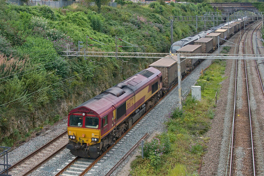 66172, 11.36 Ditton Foundry-Dollands Moor (6O16, 192E) & 390001, VT 15.13 London Euston-Preston (1P88, RT), A508 bridge 
 Due to the reduction in normal traffic as a result of union action paths became available for freight that avoided the normal time-consuming diversion through Northampton. 66172 leads the 11.36 Ditton Fondary to Dollands Moor service through Roade taken from the village's Hyde Road bridge. The freight is just passing one of the Avanti services that managers were able to run, the 15.13 Euston to Preston train worked by 390001. 
 Keywords: 66172 11.36 Ditton Foundry-Dollands Moor 6O16 390001 15.13 London Euston-Preston 1P88 A508 bridge EWS DB Cargo AWC Pendolino