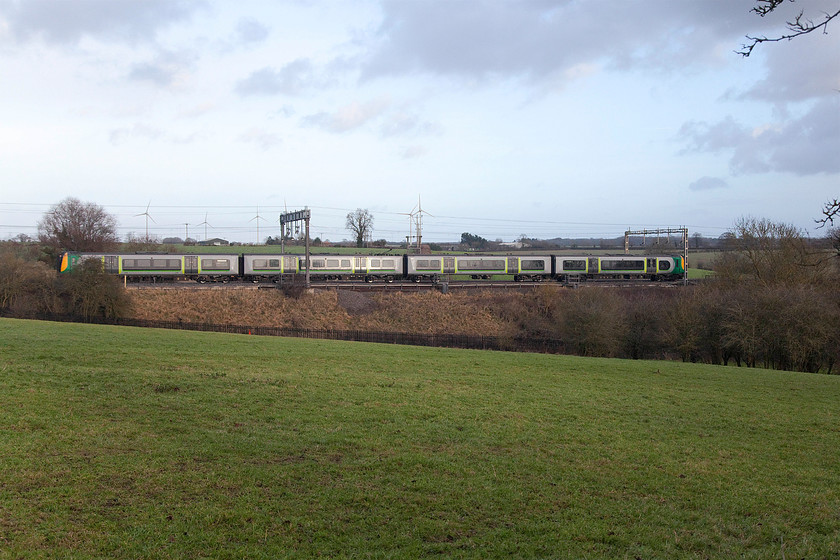 350109, LN 13.46 London Euston-Crewe (1U37, RT), Roade Hill 
 Taken from a gateway on Roade Hill between Roade and Ashton in Northamptonshire, 350109 takes the down fast line with the 13.46 Euston to Crewe. This four-car Desiro EMU just fits in the frame of the camera but the picture could have been taken just a fraction of a second earlier so the front was not partly obscured. However, I don't like cheating and using the camera's rapid fire function preferring to try and judge things better by eye; the proper way! 
 Keywords: 350109 13.46 London Euston-Crewe 1U37 Roade Hill