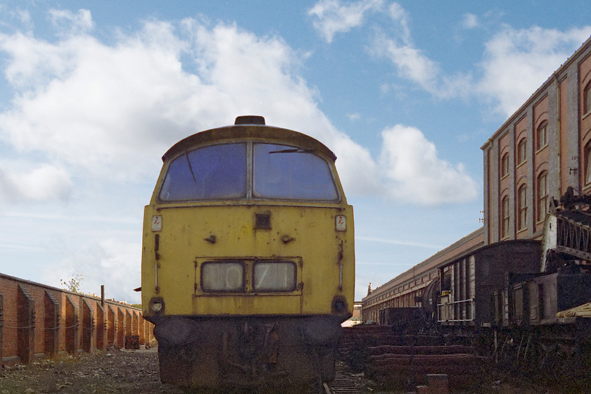 D1071, awaiting cutting, Swindon Works 
 Since my last visit in April, D1071'Western Renown' has moved from the Swindon scrap-lines to the back of the works. Still looking complete and with its experimental cab ventilator 'Trooper' sits awaiting its fate. Note the ex. GWR brake van and crane to the right of the picture.