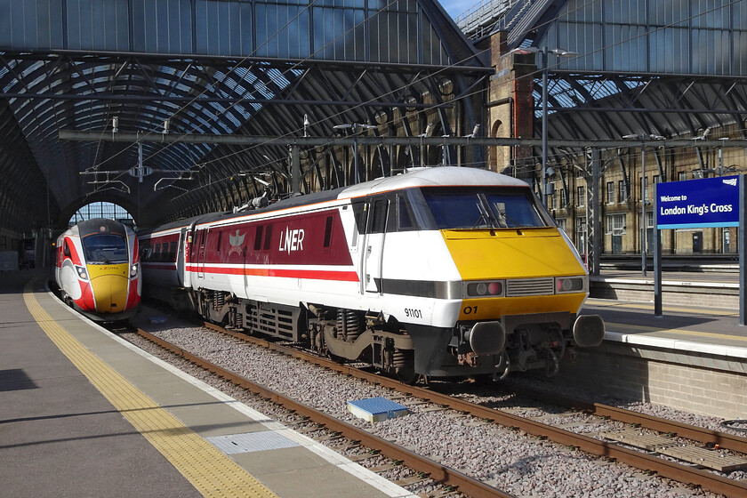 801230, GR 09.06 London King's Cross-York (1N81, RT) & 91101, GR 09.03 London King's Cross-Leeds (1D07, 4L), London King's Cross station 
 Having just worked up from Leeds a little earlier, 91101 'Flying Scotsman' will return leading the 1D07 09.03 service. Next to it, 801230 will leave just after the IC225 working the 09.06 to York. In the last half half and hour that I spent at King's Cross I observed no fewer than three IC225 sets in operation. I remember saying back in 2019 when the Azumas entered service that the IC225s would be sorely missed but here we are some five years later and they are still very much in frontline service! 
 Keywords: 801230 09.06 London King's Cross-York 1N81 91101, GR 09.03 London King's Cross-Leeds 1D07 London King's Cross station LNER Azuma IC225 Flying Scotsman