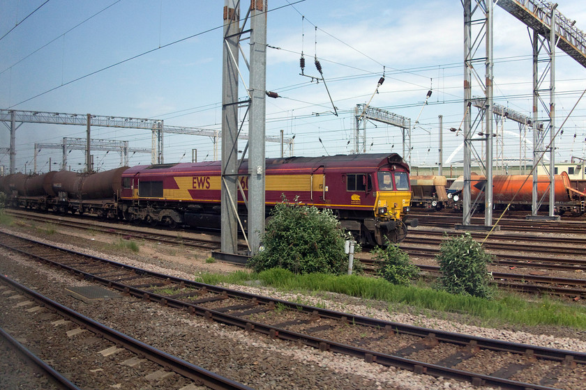 66047, unidentified tanker train, Wembley Yard 
 As we passed Wembley Yard in the 11.13 Milton Keynes to East Croydon 66047 is seen at the head of a tanker train. From what I can see in the image, they appear to be china clay tanks. 
 Keywords: 66047 Wembley Yard