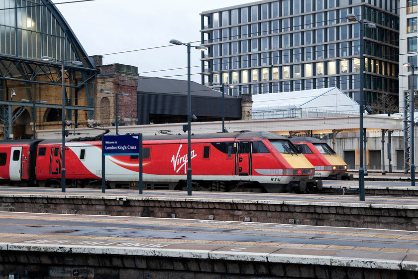 91118, GR 09.00 London King`s Cross-Edinburgh (1S09) & 91120, GR 08.00 London King`s Cross-Edinburgh (1S07), London King`s Cross station 
 Two northbound Virgin East Coast trains wait at London King's Cross. Nearest the camera is 91118 that will work the 09.00 to Edinburgh whilst behind it is 91120 that will leave first with the 08.00 to Edinburgh. Note the large tent like structure in the background. This is the King's Cross pop-up theatre that I went to a month ago to see the late David Bowie's Lazarus play. 
 Keywords: 91118 09.00 London King`s Cross-Edinburgh 1S09 91120 08.00 London King`s Cross-Edinburgh 1S07 London King`s Cross station