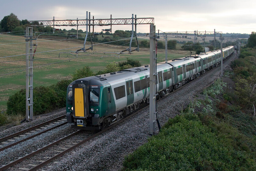 350130, LN 16.33 Crewe-London Euston (1U38, 1E), Blisworth 
 In very poor early evening lighting, as was the case at the same time last week, see.... https://www.ontheupfast.com/p/21936chg/C385395351/x59-lsl-s-1z41-02-09-22 350130 leads another Desiro past Blisworth working the 16.33 Crewe to Euston service. 
 Keywords: 350130 16.33 Crewe-London Euston 1U38 Blisworth London Northwestern Desiro