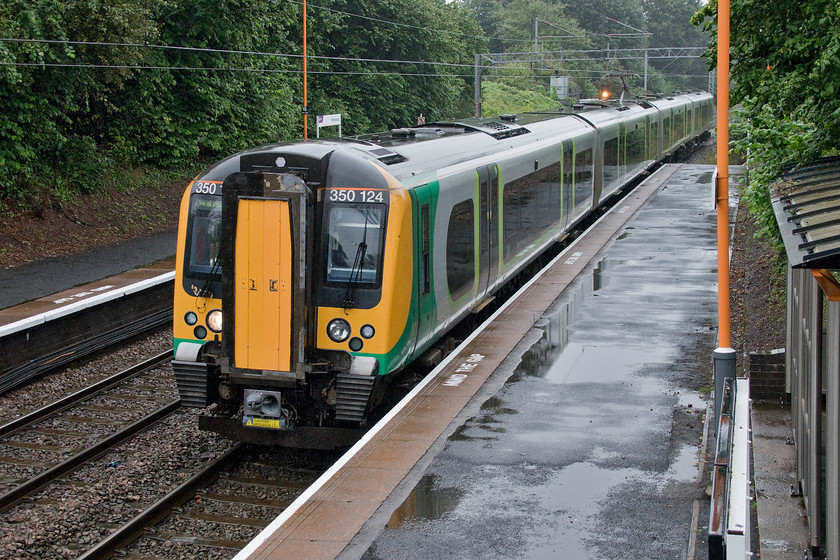 350124, LN 11.22 Wolverhampton-Walsall (2A21, 5L), Hamstead station 
 The 11.22 Wolverhampton to Walsall 2A21 service arrives into a wet Hamstead station formed by 350124. Hamstead station was opened as Hamstead and Great Barr by the Grand Junction Railway on 4 July 1837. It once had some sidings that were served by a tramway from the Hamsted colliery that closed in 1965. 
 Keywords: 350124 11.22 Wolverhampton-Walsall 2A21 Hamstead station