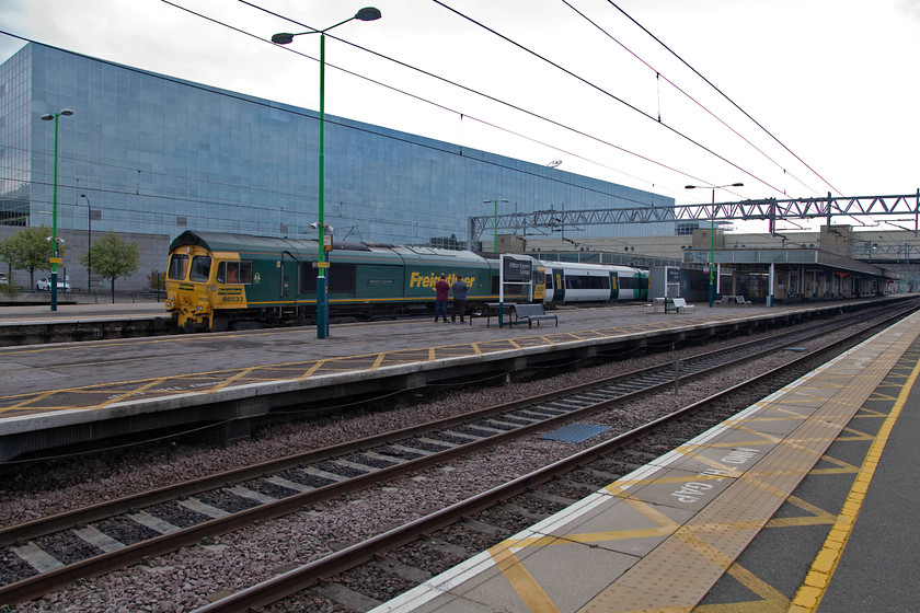 66533, 04.25 Felixstowe-Lawley Street (4M88), Milton Keynes Central station 
 According to what side of 66533 is viewed it could be seen named as either 'Hanjin Express' or 'Senator Express'. Either way, it is seen at speed through Milton Keynes station with the 4M88 04.25 Felixstowe to Lawley Street Freightliner. In this image, it looks like it's towing a Southern class 377 but this is on an adjacent platform with a couple of empty Freightliner flats behind the 66. 
 Keywords: 66533 04.25 Felixstowe-Lawley Street Freightliner 4M88 Milton Keynes Central station