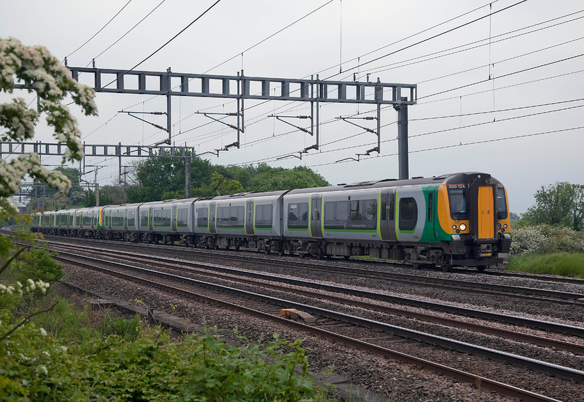 350124 & class 350, LN 17.36 London Euston-Crewe (1U45, 35L), Ashton Road Bridge 
 An 8-car formation with 350124 leading passes just near to Roade on the down fast working the 17.36 London Euston to Crewe. Working these trains on the fast lines requires these class 350s to work at their 110mph top speed where permitted so as not to hold other traffic up. 
 Keywords: 350124 1U45 Ashton Road Bridge