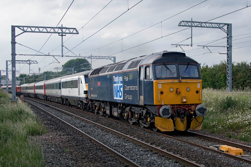 47813, 82136 & 90035, 17.53 Kettering-Bedford (3Q65, RT), Irchester SP927667 
 On the recently wired MML at Irchester just south of Wellingborough the ROG/DATS overhead line inspection train makes its way along the up fast line. This test train is composed of an eclectic mix of stock with 47813 'Jack Frost' leading former GA DVT 82136. Beyond the following four former GA Mk.IIIs 90035 can be seen. This was the first run of four made up and down the fast lines undertaking various tests as the 3Q65 17.53 Kettering to Bedford. 
 Keywords: 47813 82136 90035 17.53 Kettering-Bedford 3Q65 Irchester SP927667 ROG DATS MML Overhead Line Inspection Train Jack Frost