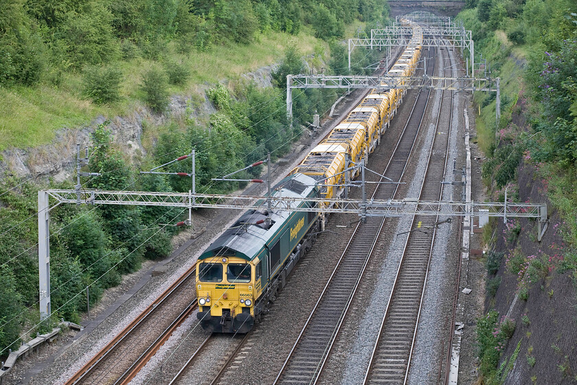 66563, Willesden-Birmingham International HOBC (6Y15), Roade cutting 
 The massive and extremely weighty HOBC (High Output Ballast Cleaner) train is seen making its way slowly through Roade cutting led by Freightliner's 66563 with 66547 out of site at the rear. The train was heading for the Birmingham International area from Willesden in order to undertake ballast cleaning as part of a wider engineering programme overnight and through the next day (Sunday). 
 Keywords: 66563 Willesden-Birmingham International HOBC 6Y15 Roade cutting Freightliner