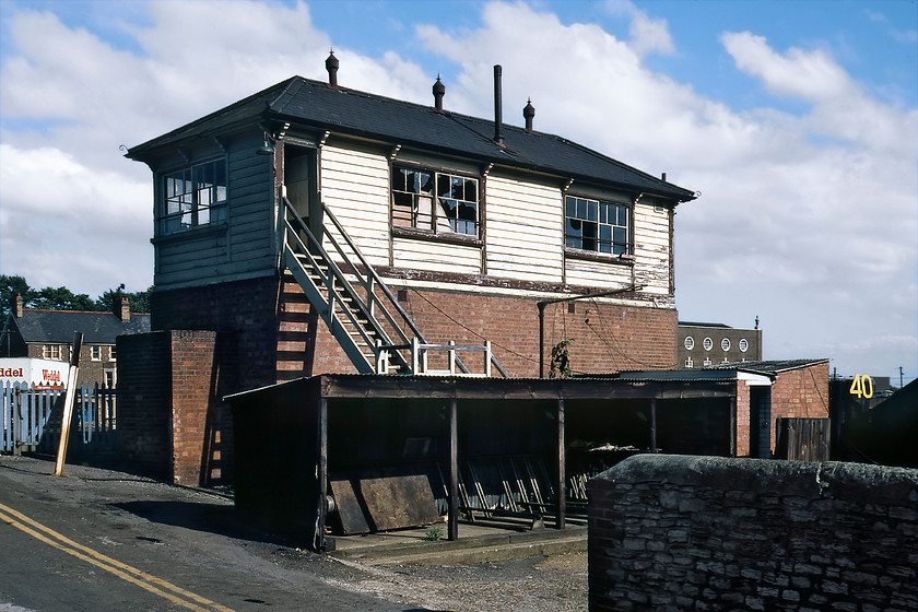 Oxford Station South signal box (GW, 1908) 
 On a sunny August afternoon, the rear of Oxford Station South signal box is seen from the road that used to cross the line at this point over what would have been a very busy level crossing. The box is a Great Western structure with a timber top sitting on a brick base dating from 1908. In this image, it looks in a very sorry state having been closed for seven years following Oxford's resignalling. Not long after this photograph was taken the box was demolished. 
 Keywords: Oxford Station South signal box