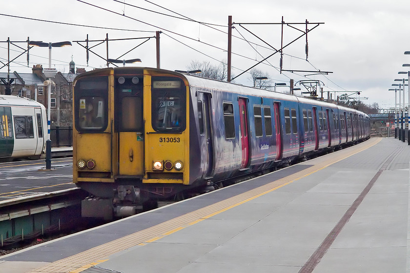 313053, GN 11.54 Hertford N-Moorgate (2J58, 1E), Finsbury Park station 
 313053 slows for its Finsbury Park stop forming the 11.54 Hertford North to Moorgate working. I caught this train back to Moorgate and then the the tube back to Holborn where my wife was waiting in our hotel with numerous shopping bags! 
 Keywords: 313053 2J58 Finsbury Park station