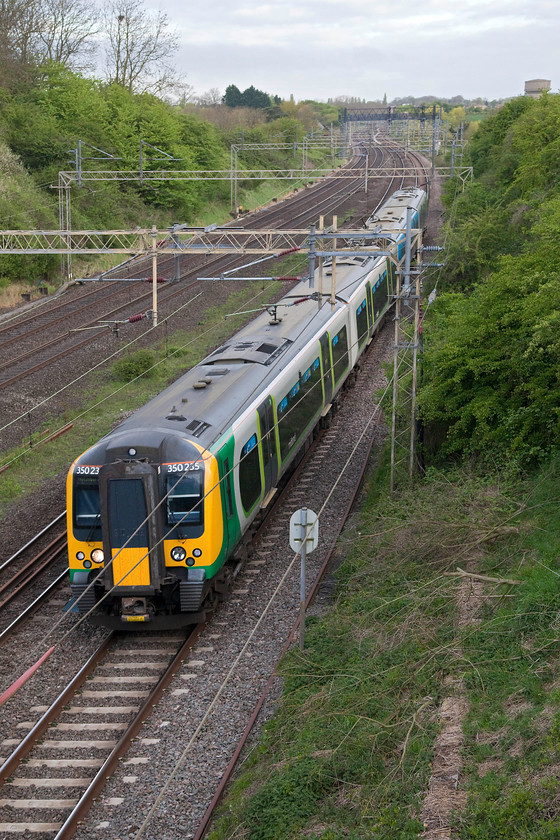 350235, LM 06.50 Northampton Riverside-Milton Keynes Central ECS (5K08), Victoria Bridge 
 Running a little late, the 06.50 Northampton Riverside sidings to Milton Keynes ECS was supposed to run fast and in-front of the previous up service train. However, it is seen behind it here passing Victoria Bridge between Northampton and Milton Keynes. 
 Keywords: 350235 5K08 Victoria Bridge