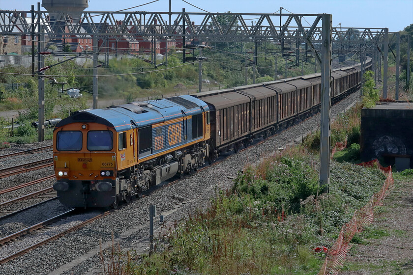 66775, 06.34 Dollands Moor-DIRFT (6M45, 35L), site of Roade station 
 The daily 'water train' passes through Roade but on the down fast line taking to 'old' line via Weedon to Rugby. GBRf's 66775 'HMS Argyle' is leading the 6M45 06.34 Dollands Moor to DIRFT that, on arrival at Rugby, will run round its train to then head the short distance south to Daventy's freight terminal. Despite being re-timed to take account of this logistical inconvenience the train still arrived over half an hour late. 
 Keywords: 66775 06.34 Dollands Moor-DIRFT 6M45 site of Roade station HMS Argyle