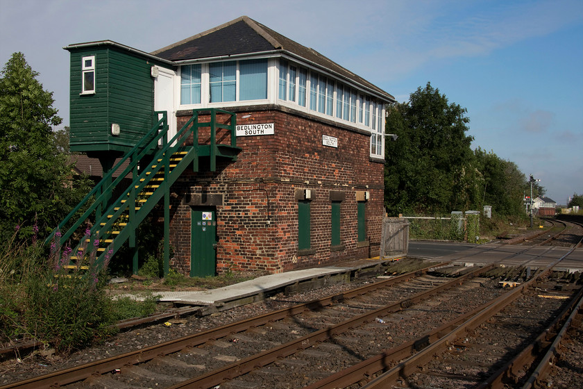 Bedlington South signal box (NE, date not known) 
 The impressive Bedlington South signal box is seen with its near-identical North counterpart in the distance beyond the semaphores. The box was constructed the North Eastern Railway being of a slightly earlier design than the 1912 Bedlington North box with a hipped roof. I suspect that it dates from around 1880 with the exact date not known. The box may well control a very short section of track but the track layout is complicated and it also controls the level crossing that is in view. 
 Keywords: Bedlington Soith signal box