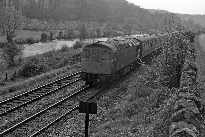 Class 33, unidentified Bristol Temple Meads-Porstmouth Harbour working, Turleigh Hill ST812603 
 A pretty poor quality photograph with motion blur and taken into the afternoon sun taken in the Avon valley near the village of Turleigh sees a Class 33 heading east towards its next stop at Bradford-on-Avon. Carrying a headcode of 89 indicates that the train is a Bristol to Portsmouth Harbour service via Salisbury. Notice the cast SW sign in the foreground warning people who may be using at a little-used occupation crossing a short distance away. 
 Keywords: Class 33, unidentified Bristol Temple Meads-Porstmouth Harbour working, Turleigh Hill ST812603