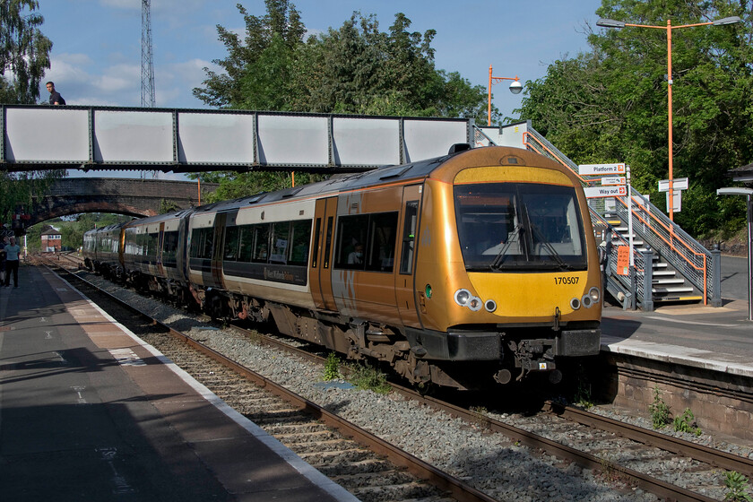 170507, LN 16.50 Birmingham New Street-Hereford (1V21, 1L), Droitwich Spa station 
 170507 leads another West Midlands Railway unit into a pleasantly warm and sunny Droitwich station. The pair of units have just come down Lickey having taken the Midland route south of the city to now join former Great Western territory as the 16.50 New Street to Hereford 1V21 service. As this train avoided the problems on the Kidderminster route into Birmingham it was almost on-time and arrived at its destination just one minute adrift. 
 Keywords: 170507 16.50 Birmingham New Street-Hereford 1V21 Droitwich Spa station West Midlands Railway