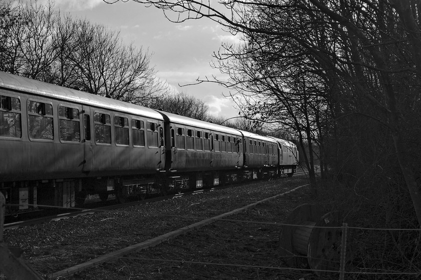 D1015, return leg of The Chiltern Champion 1, 12.40 London Marylebone-Oxford (1Z55), Wendlebury SP561182 
 I am not a particular fan of desaturated digital images but in this case, I have made an exception. The original colour image was badly handled by the control systems within the camera and it was actually going to be easier to turn it to black and white than excessively manipulate it within Photoshop. I actually like the lighting in this form and it tells a tale in that this line will be closing in just five days time never to be seen like this again. Notice the tree clearance to the right in anticipation of this work. D1015 'Western Champion' gets the return leg of The Chiltern Champion away from Bicester at Wendlebury. 
 Keywords: D1015 The Chiltern Champion 1, 12.40 London Marylebone-Oxford 1Z55 Wendlebury SP561182