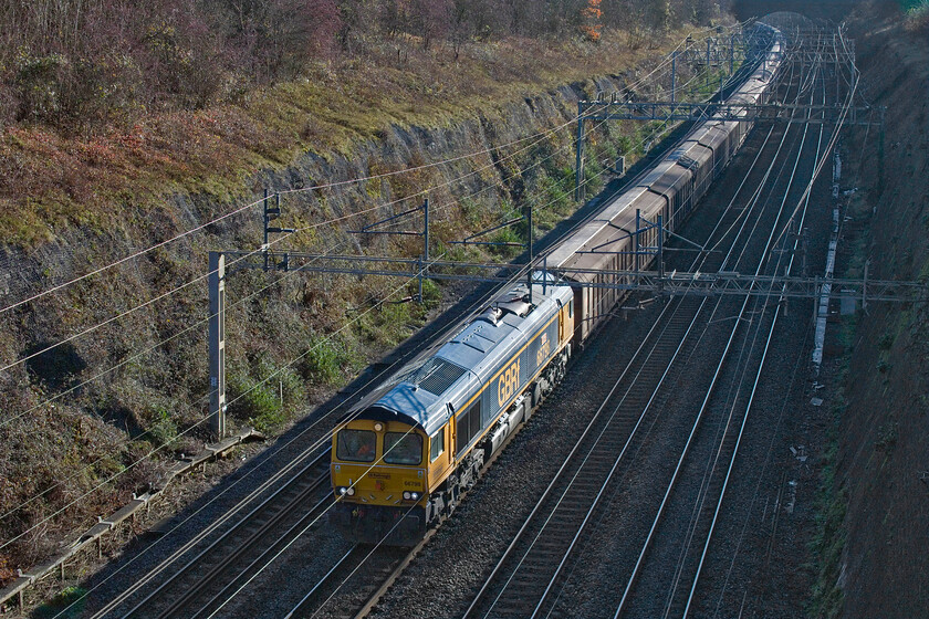 66798, 06.53 Dollands Moor-DIRFT (6M45, 3E), Roade cutting 
 Having photographed 66798 'Justine Langton' for the first time just five days previously working the 6M45 06.53 Dollands Moor to Daventry 'water train' here it is again on the same working! This time the GBRf locomotive is catching some winter. sunshine passing through Rode's impressive one point five-mile long cutting. 
 Keywords: 66798 06.53 Dollands Moor-DIRFT 6M45 Roade cutting Justine Langton