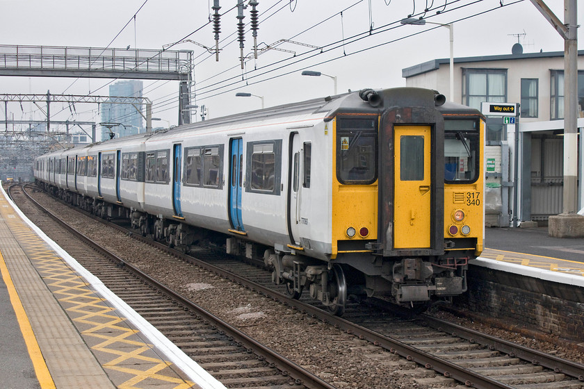 317340 & 317510, LE 13.12 London Liverpool Street-Hertford East (2O32, 2L), Bethnal Green station 
 Two Greater Anglia class 317s, numbers 317340 and 317510 stop at Bethnal Green station forming the 13.12 Liverpool Street to Hertford East service. The familiar site of these units, very nearly forty years old will soon become a thing of the past for east Londoners as they are about to be withdrawn and will then make their final journey to the scrap man. 
 Keywords: 317340 317510 13.12 London Liverpool Street-Hertford East 2O32 Bethnal Green station