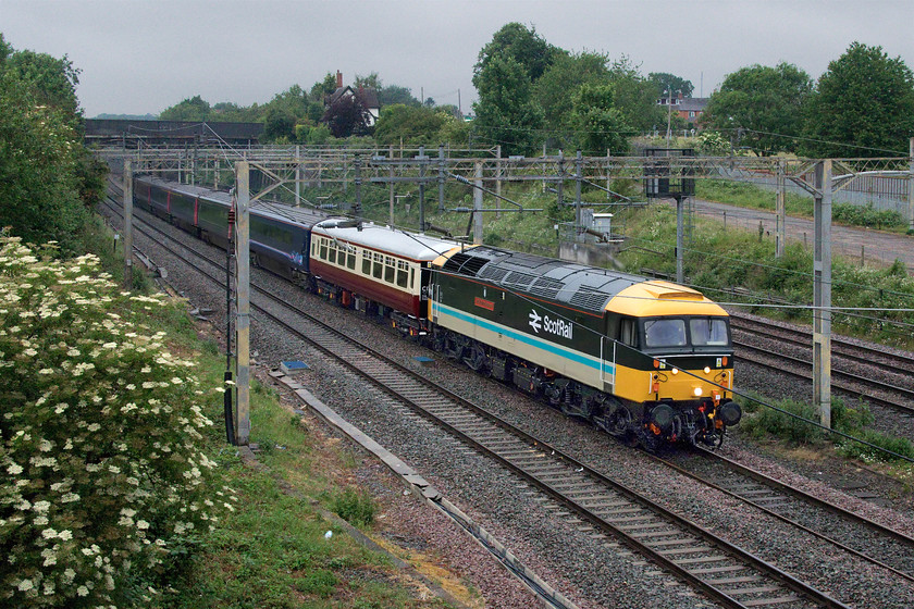 47712 & 43083, 07.14 Crewe HS-Eastleigh Arlington (5Z36, 2L), site of Roade station 
 I so nearly missed this working! I had spotted postings about the progress of this move from Crewe to Eastleigh and realised that it was fairly early. But it's a good job that I had Open Train Times running as when it got to Hilmorton Junction south of Rugby it suddenly was put on the fast. I was not even dressed and had not taken my wife her morning coffee so had to dash about and then jog the relatively short distance to the site of Roade's station to get the train and I did so by the skin of my teeth! It was such a dull morning for early June but the superb 47712 'Lady Diana Spencer' brightened up the scene in its reproduction ScotRail livery. It was leading a Mk.1 acting as a barrier coach to five former GWR HST Mk.IIIs that I believe were going for painting as they belong to LSL which is trying to develop its place in the contemporary charter market. At the rear was EMR branded HST power car 43083. 
 Keywords: 47712 43083, 07.14 Crewe HS-Eastleigh Arlington 5Z36 site of Roade station Lady Diana Spencer LSL Arlington Fleet Services FGW East Midlands Railway EMR