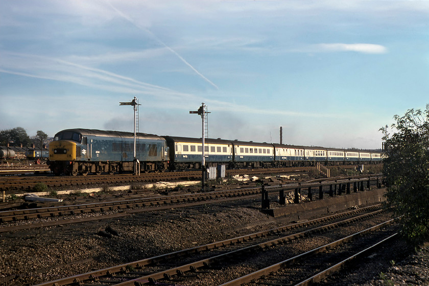 45114, 13.01 London St. Pancras-Sheffield (1E40), Brent yard 
 45114 is getting into its stride as it passes through north London with the 1E40 13.01 St. Pancras to Sheffield express. It is approaching the southern end of Brent Yard with the line to Dudding Hill Junction dropping away to the right. Just behind the Peak is one of the famous class 127 Bed-Pan DMUs. 
 Keywords: 45114 13.01 London St. Pancras-Sheffield 1E40 Brent yard