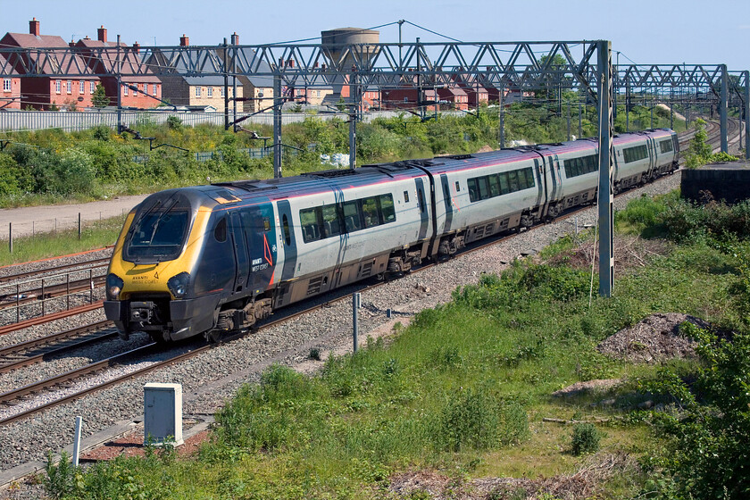 221106, VT 14.15 London Euston-Birmingham New Street (9G26, RT), site of Roade station 
 221106 spoils the afternoon peace and quiet of the village of Roade passing with the 14.15 Euston to Birmingham New Street service. I have questioned it before but had no response, what is the thinking behind running an expensive to run diesel unit under fully energised wiring for one hundred ad twelve miles between the UK's largest two cities? The sooner that these dreadful units are taken out of service later this year the better! 
 Keywords: 221106 14.15 London Euston-Birmingham New Street 9G26 site of Roade station AWC Avanti West Coast Voyager