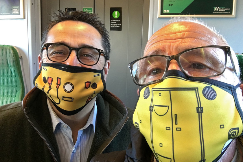 Rail travel COVID-19 style 
 The face of train travel COVID-19 style! Andy wearing the Class 40 (marker disk type) face mask and yours truly wearing the Class 50 version (post refurbished with central headlight) enjoying our journey from Northampton to New Street aboard 350251. It was notable that throughout the journey from Northampton to Nottingham, including around all the stations, there was almost complete compliance with the face mask policy.

Many other variants of these masks are available from.....https://pixelshack.co.uk/collections/face-masks 
 Keywords: Rail travel COVID-19 style