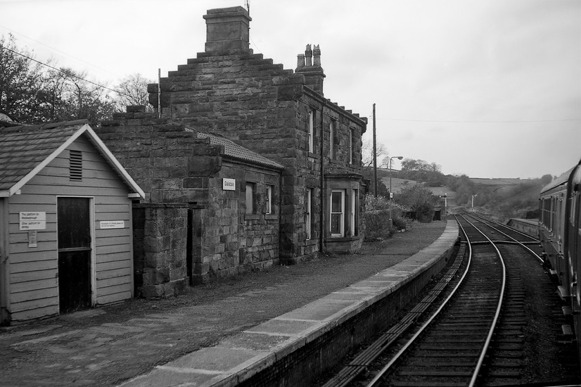 Glaisdale station 
 On leaving Glaisdale station I directed my camera back towards the rather attractive NER station building. Then and now the building is a private residence. I have in my contemporary notes that there was a pile of building materials on the platform, out of view in this shot, appearing to indicate that the dreaded BR bus shelter was about to be constructed. Indeed, in the image of the station from a very similar angle as this on on the Wikipedia page, it is in full view, see.... https://en.wikipedia.org/wiki/Glaisdale_railway_station#/media/File:Glaisdale_station_geograph-3561181-by-Ben-Brooksbank.jpg 
 Keywords: Glaisdale station