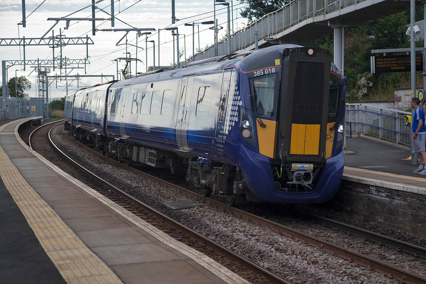 380018, SR 15.16 Glasgow Central-Edinburgh Waverley (2Y48, 2L), Shotts station 
 Taken against the afternoon light but I suppose I should be grateful as the sun was at a bit of a premium now being a particularly dull Friday afternoon! 380018 arrives at Shotts station forming the 15.16 Glasgow Central to Edinburgh service. Behind the train is part of an extraordinarily long disabled access footbridge that comes down from the street level of the aptly named Station Road above the station to the right. 
 Keywords: 380018 15.16 Glasgow Central-Edinburgh Waverley 2Y48 Shotts station