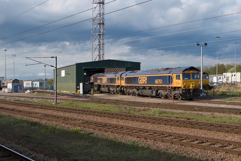 66739, 66741, 66751 & class 66, stabled, Peterborough yard 
 Under threatening April skies, a collection of class 66s are seen stabled at GBRF's Peterborough servicing and maintenance facility. To the extreme left is 66739 'Bluebell Railway' and then in the foregrounds are 66741 and 66751. Another two are seen, one inside the shed and the other tucked away at the back. This facility is located on the site of the former diesel depot a short distance to the north of the station. 
 Keywords: 66739 66741 66751 class 66 Peterborough yard Bluebell Railway