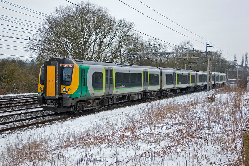 350119, LM 09.14 Birmingham New Street-London Euston, Roade 
 The Desiros have been operating on the Birmingham to London route for London Midland since the summer of 2007 following the demise of Silverlink. They have proved to be reliable and dependable if a little dull! 350119 passes Roade with the 09.14 Birmingham New Street to Euston service on a snowy January morning. 
 Keywords: 350119 09.14 Birmingham New Street-London Euston Roade London North Midland Desiro