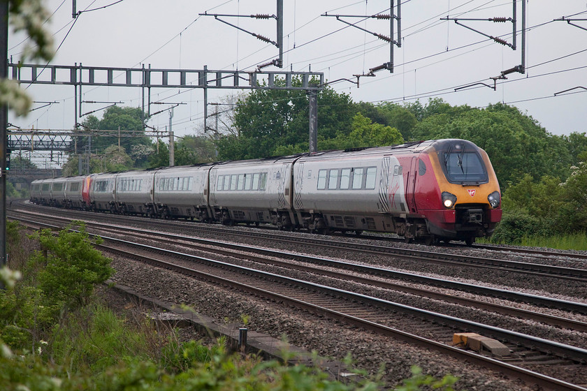 221101 & 221117, VT 18.23 London Euston-Shrewsbury (9J38, 5L), Ashton Road Bridge 
 The 18.23 London Euston to Chester passes just south of Roade near Northampton. The two units are 221101 'Louis Blriot' and 221 117 'The Wrekin Giant' . I can imagine that a journey from London to Chester on one of these units would be a bit cramped and noisy, whilst fast they are not great to ride in! 
 Keywords: 221101 & 221117 9J38 Ashton Road Bridge