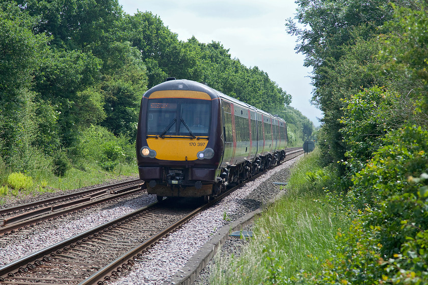 170397, XC 11.27 Stansted Airport-BNS (1N50, 2L), Egleton SK869070 
 Cross Country's 11.27 Stansted Airport to Birmingham New Street 1N50 working passes Egleton just south of Oakham worked by 170397. Whilst 170s have been successful workhorses, depending on where you sit in the train they are prone to noise and vibration. Some of the interiors are also looking a little worn now. This shot is a little head on and back-lit but it shows an English Summer scene nicely; very green but very overcast! 
 Keywords: 170397 1N50 Egleton SK869070