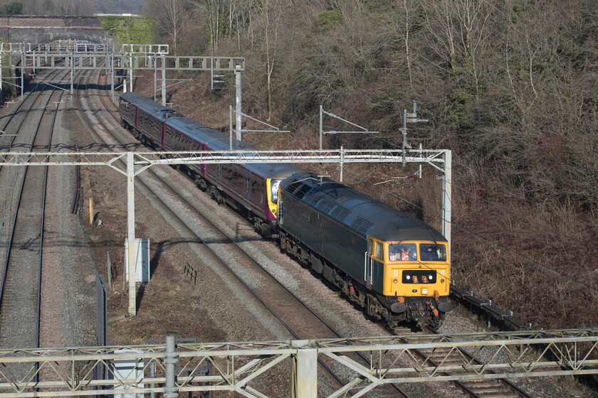 47727 & 360120, 10.29 Northampton EMD-Cricklewood South Sidings (5Q97, 3L), A508 bridge 
 Vintage motive power for the 5Q97 10.29 Northampton to Cricklewood drag with 47727 'Edinburgh Castle/Caisteal Shun Eideann' leading the train past Roade. Whilst the Class 47 is approaching its sixtieth birthday (2024) the EMR Desiro unit being dragged south, 360120, is a youngster at twenty-one years old. The Class 360s that operate on the st. Pancras to Corby MML route are periodically dragged from London to Northampton's Siemens depot for exams and maintenance but I still don't understand why they cannot move under their own electrical power? 
 Keywords: 47727 360120 10.29 Northampton EMD-Cricklewood South Sidings 5Q97 A508 bridge Edinburgh Castle/Caisteal Shun Eideann