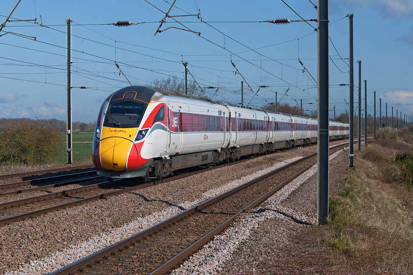 801222, GR 05.48 Edinburgh Waverley-London King's Cross (1E02, 4E), Sandy TL176510 
 It's not quite an A4, a Deltic or even an IC225 but one cannot really argue that 801222 makes a fine sight as it tears past Sandy's New Zealand bridge working the 05.48 Edinburgh Waverley to King's Cross 1E02 service. Using my zoom lens on the Canon 5D I had to use 1:4000/sec. shutter speed to 'freeze' the action. Close examination reveals that this was successful with the drillings in the wheel brake discs even appearing to be sharp, modern camera technology can be superb! 
 Keywords: 801222 05.48 Edinburgh Waverley-London King's Cross 1E02 Sandy TL176510 LNER Azuma