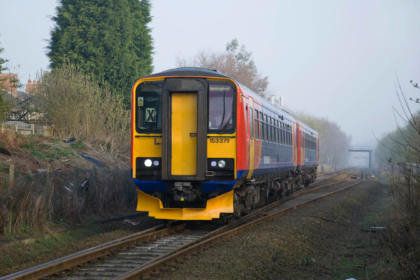 153379, EM 07.39 Mansfield Woodhouse-Nottingham (2D02), Newstead level crossing 
 East Midlands Trains' 153379 slows for its stop at Newstead station working the 07.39 Mansfield to Nottingham service. The train is about to cross the level crossing to the north of the station that used to provide access to the Newstead Colliery that opened in 1874 succumbing in 1987 after surviving the 1984/5 strike. 
 Keywords: 153379 07.39 Mansfield Woodhouse-Nottingham 2D02 Newstead level crossing