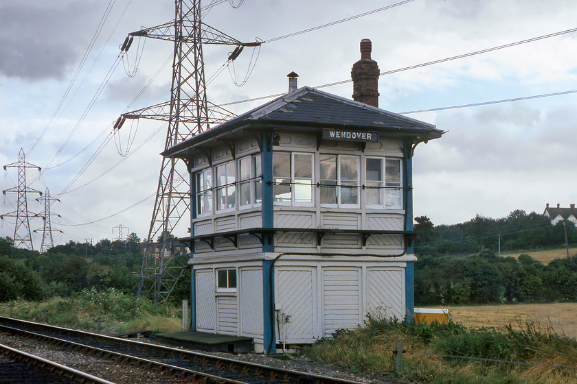 Wendover signal box (Met, 1889) 
 The Metropolitan Railway (or Met. for short) has a fascinating history that books have been written about. More normally associated with the more traditional underground lines the company also expanded deep into Buckinghamshire with its northern extension terminating in the village of Brill just south of Bicester. Their signal boxes were of a very distinctive design being almost square, with this one at Wendover being their standard size at approximately seventeen by twelve feet. They usually came with the three window bays on the ends and front and came with the differently orrientated timber strip work to the panels that mirrored the windows. They certainly are a delightful design and very different to some of the austere designs that emerged over the years, for example at Kettering Junction, see.... https://www.ontheupfast.com/p/21936chg/29663552604/kettering-junction-signal-box Wendover box opened in 1889 and closed in 1984 with control moving to the newly constructed Marylebone control box. It's a shame in this photograph that the high tension wire pylons in the immediate background spoil the scene somewhat. These particular monstrosities start their march through the Chilterns at Uxbridge (West London) and end up at a large substation deep in the countryside south-west of Winslow. 
 Keywords: Wendover signal box Metropolitan Railway