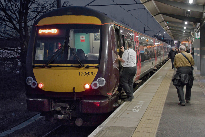 170620, XC 18.22 Birmingham New Street-Stansted Airport (1L52, RT), Nuneaton station 
 With Andy walking the length of 170620 assiduously collecting the carriage numbers of the 18.22 Birmingham New Street to Stansted Airport pauses at Nuneaton station. This one of CrossCountry's services on this route that was actually running right through rather than terminating at Leicester for passengers to then board a bus in order to reach Peterborough; are they actually running a railway company I ask myself? 
 Keywords: 170620 18.22 Birmingham New Street-Stansted Airport 1L52 Nuneaton station CrossCountry Turbo