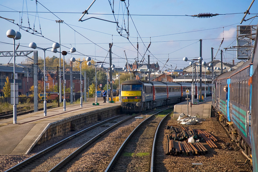 37425, LE 13.17 Great Yarmouth-Norwich (2P21) & 90007, LE 14.00 Norwich-London Liverpool Street (1P43), approaching Norwich station 
 A view from the droplight at the rear of the 13.17 Great Yarmouth to Norwich as it arrives at its destination sees 90007 'Sir John Betjeman' at the head of the 14.00 to Liverpool Street. Up at the front of the 2P21 is 37425 'Sir Robert McAlpine' that has been enjoyed thrashing access the Norfolk Broads. Notice the young enthusiast further down the train, he had done the same out and back trip as me with his mum who rather than indulging in a spot of window leaning sat in a sumptuous Mk. II seat reading her book! 
 Keywords: 37425 13.17 Great Yarmouth-Norwich 2P21 90007 14.00 Norwich-London Liverpool Street 1P43 approaching Norwich station Greater Anglia GA Sir John Betjeman