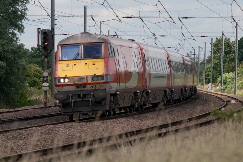 82202, GR 12.00 Edinburgh-London King`s Cross, (1E14, 4E), Offord D`Arcy TL213652 
 DVT 82202 leads the 12.00 Edinburgh to London King's Cross 1E14 past Offord D'Arcy taking one of its reverse curves at some speed as it heads south. The distant colour light (P327) is at caution indicating that the gates of the busy level crossing in the nearby village of Offord Clunny are raised.