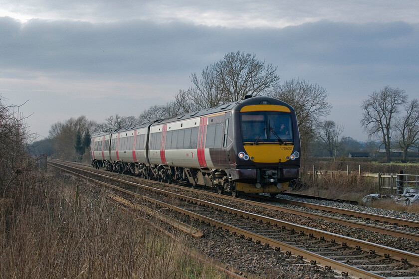 170622, XC 13.22 Birmingham New Street-Cambridge (1L42, RT), Frisby level crossing 
 With the trees displaying a very wintery look 170622 passes Frisby just west of Melton Mowbray working CrossCountry's 1L42 13.22 Birmingham to Cambridge service. I first visited Frisby back in 1981, see.... https://www.ontheupfast.com/p/21936chg/29672774204/frisby-station-signal-box but I think that this may be the first (of three taken today) one of a train passing the level crossing! 
 Keywords: 170622 13.22 Birmingham New Street-Cambridge 1L42 Frisby level crossing