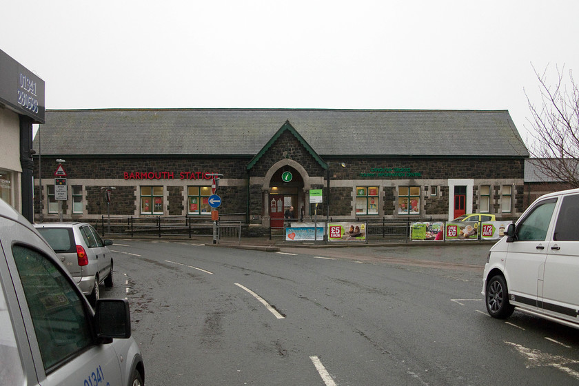 Frontage, Barmouth station 
 Barmouth station was opened in 1867 and retains its imposing impressive building that is now in use as a tourist information office. Andy is just seen emerging from the doors having 'bagged' the station even though he had visited it before during a family holiday. 
 Keywords: Frontage Barmouth station