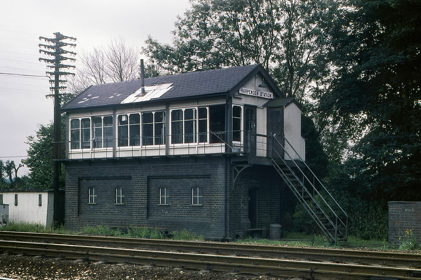 Harpenden Station signal box (LMS, date not known) 
 Harpenden Station signal box was an LMS built structure but I have no date of construction or other information about the box. If anybody can furnish me with further information please get in contact. In this view, just three months prior to its closure, the roof looks to be in a parlous state. Notice the telegraph post to the left of the box, something else that has disappeared from the railway scene. 
 Keywords: Harpenden Station signal box