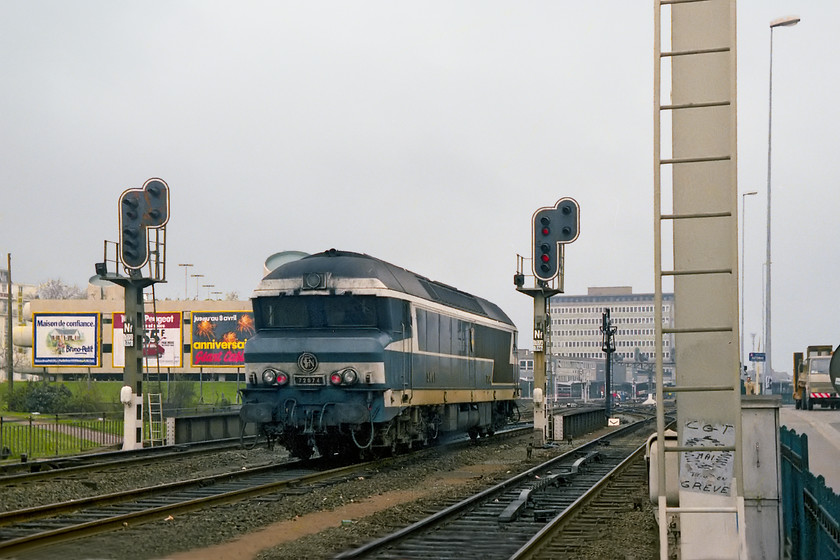 72074, running round, Quai de Malakoff, Nantes 
 Browsing Google Earth reveals that this view is still available and virtually unchanged. The multi-story carpark to the far left is now largely covered in greenery but still doing its job some forty years on, even the green fence in the foreground is the same! Despite the lines now being electrified, SNCF do not appear to have re-sgnalled as the two signals in the image are still present and exactly the same! 72074 is seen running round at the western end of Nantes station and is about to re-enter the station that is in the distance. 
 Keywords: 72074, running round, Quai de Malakoff, Nantes