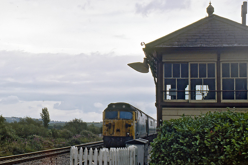 50020, 13.30 London Paddington-Penzance (1B82), Atheleny 
 Athelney is a small, isolated, linear village that straddles the River Tone at the southern edge of the Somerset Levels. The only road through the village crosses the railway at a level crossing where the signal box was located. 50020 'Revenge' is seen about the rattle the all timber classic GWR design box. The signal box was opened in 1906 following the building of the re-aligned route to Cogload Junction. This was part of the continual efforts by the GWR to shorten distances and speed up timings to the west. When the box was closed in 1985, the top section was carefully removed and now resides at Bishops Bridge on the South Devon Railway. 
 Keywords: 50020 13.30 London Paddington-Penzance 1B82 Atheleny