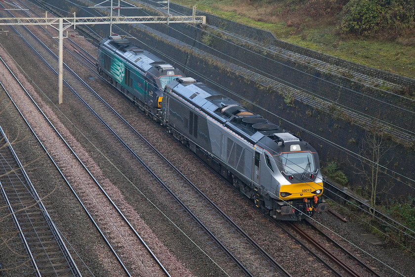 68013 & 68002, 06.47 Crewe Gresty Bridge-Wembley yard (1Z67), Roade cutting 
 To quote Forrest Gump, 'Life was like a box of chocolates. You never know what youre gonna get'. The same could be said of our hobby, I had been tracking this mysterious working on RTT during my walk around the village so I thought that it would be worth a look. Low and behold, 68013 and 68002 'Intrepid' appeared at the northern end of Roade cutting. They were forming the 06.47 Crewe Gresty Bridge to Wembley light engine move. However, I am not at all sure what this was in connection with? 
 Keywords: 68013 68002, 06.47 Crewe Gresty Bridge-Wembley yard 1Z67 Roade cutting light engine